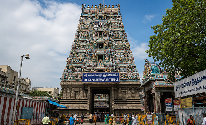 Ornate South Indian temple tower reflected in water