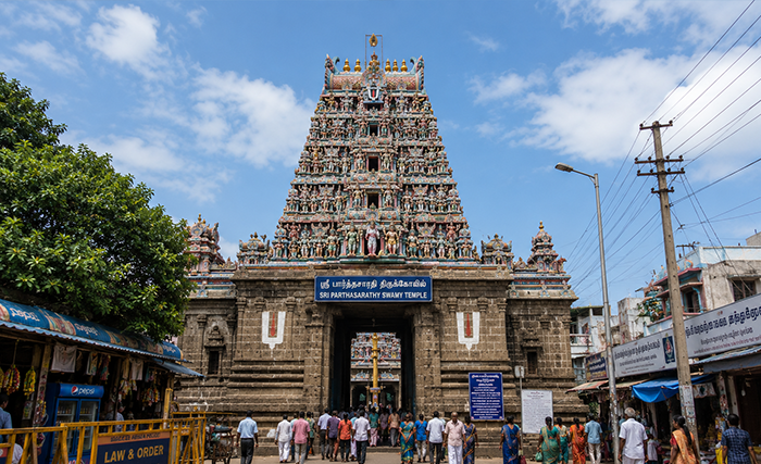Illuminated South Indian temple tower at dusk